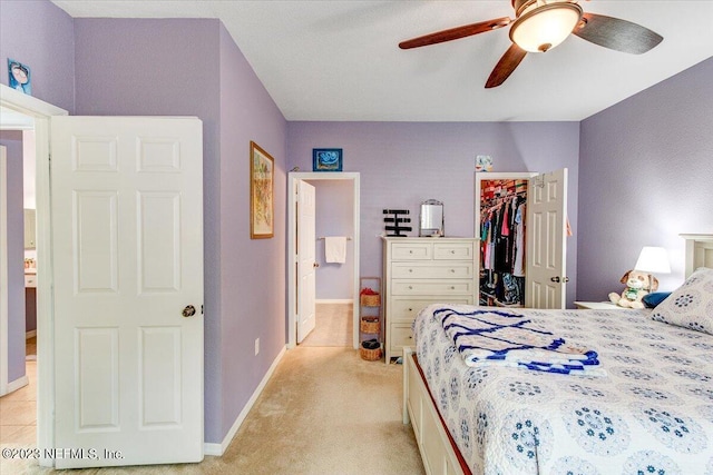 10961 Burnt Mill Rd Unit 1428, Jacksonville, FL 32256 - bedroom with a walk in closet, light colored carpet, baseboards, a ceiling fan, and a closet