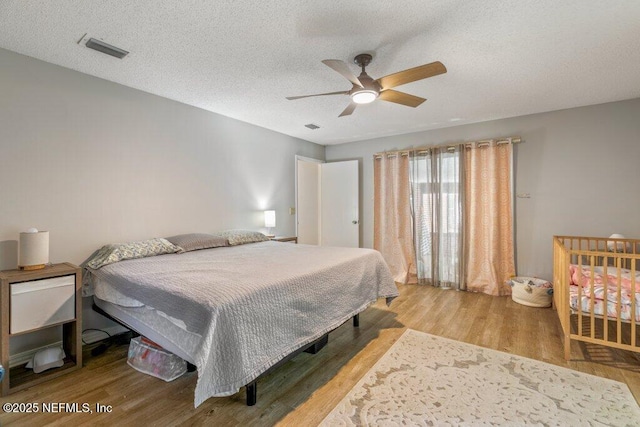 2807 Paces Ferry Rd S, Orange Park, FL 32073 - bedroom featuring wood finished floors, a textured ceiling, ceiling fan, and visible vents