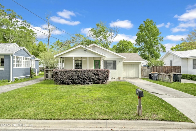 4817 Kerle St, Jacksonville, FL 32205 - bungalow-style home with concrete driveway, an attached garage, fence, a front lawn, and ceiling fan