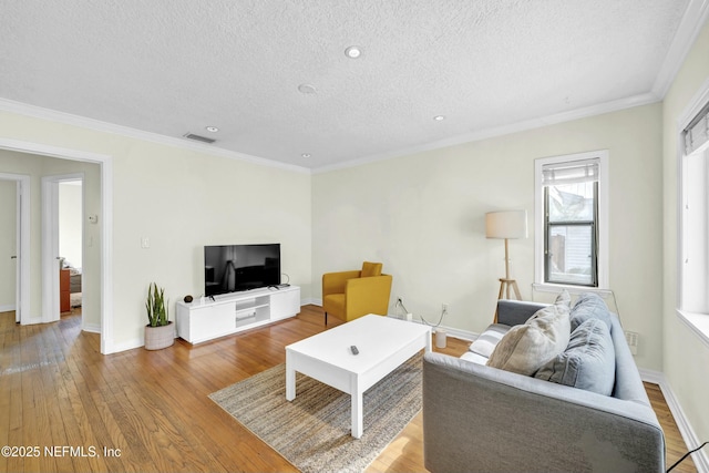 4817 Kerle St, Jacksonville, FL 32205 - living room featuring crown molding, hardwood / wood-style floors, baseboards, a textured ceiling, and visible vents