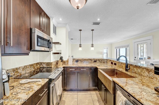 4817 Kerle St, Jacksonville, FL 32205 - kitchen featuring crown molding, visible vents, light stone countertops, and appliances with stainless steel finishes