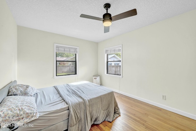 4817 Kerle St, Jacksonville, FL 32205 - bedroom featuring wood-type flooring, a ceiling fan, baseboards, and a textured ceiling
