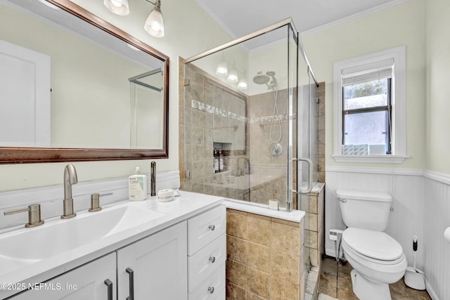 4817 Kerle St, Jacksonville, FL 32205 - bathroom featuring vanity, crown molding, toilet, a stall shower, and wainscoting