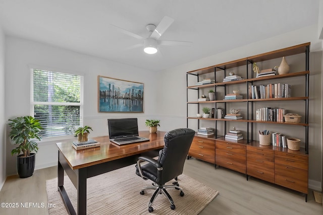 office area with light wood-style flooring and ceiling fan