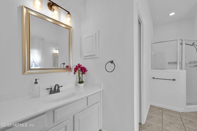 bathroom with walk in shower, tile patterned flooring, and vanity