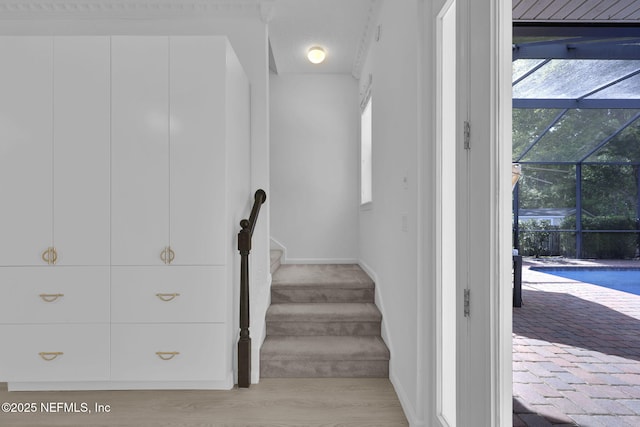 stairway featuring baseboards and wood finished floors