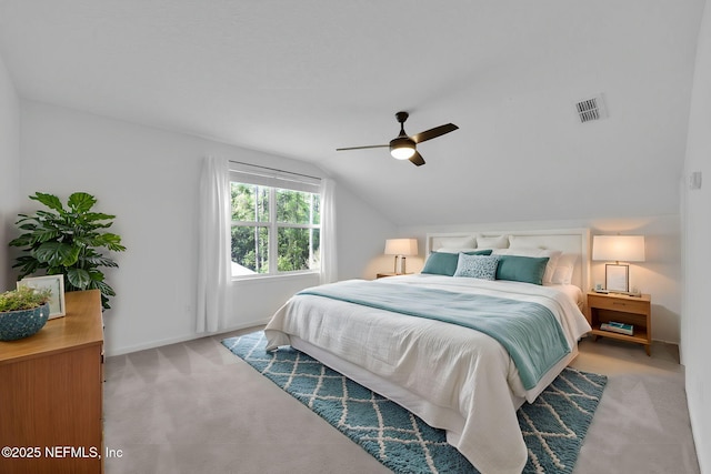 bedroom featuring lofted ceiling, baseboards, carpet floors, visible vents, and a ceiling fan