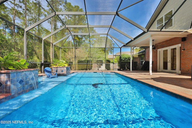 pool with a patio, ceiling fan, french doors, and glass enclosure