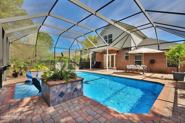 outdoor pool with a lanai and a patio