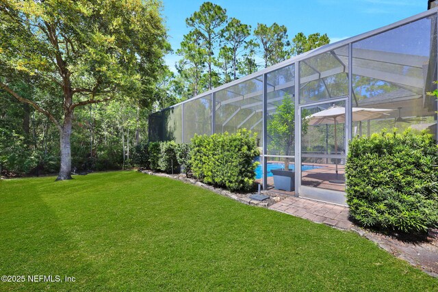 view of yard featuring an outdoor pool and a lanai