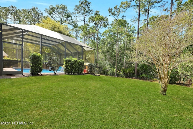 view of yard with a lanai and an outdoor pool