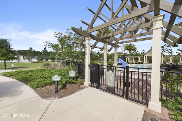 view of patio featuring a community pool and a pergola