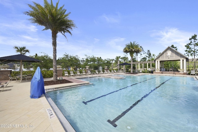 pool with a patio and a gazebo