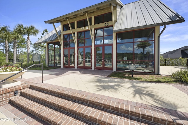 exterior space with metal roof, fence, french doors, and a patio