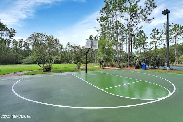 view of basketball court with community basketball court and a yard