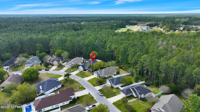 aerial view featuring a forest view and a residential view