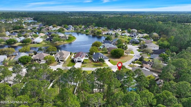 birds eye view of property featuring a residential view, a water view, and a wooded view