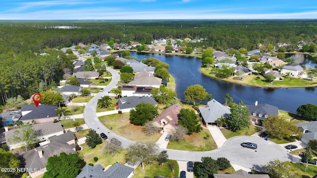 bird's eye view featuring a water view, a forest view, and a residential view