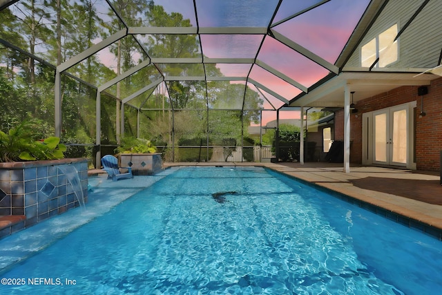 pool with french doors, a ceiling fan, a lanai, and a patio