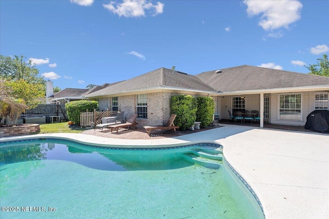view of pool with a patio area, grilling area, fence, and a fenced in pool