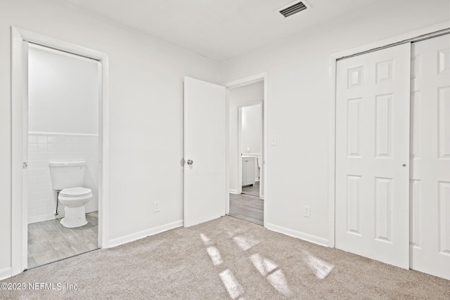 3838 Winton Dr, Jacksonville, FL 32208 - unfurnished bedroom featuring carpet flooring, connected bathroom, a closet, and visible vents
