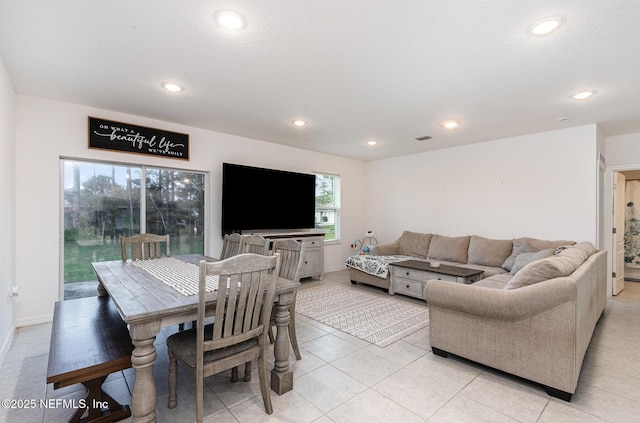 living area featuring baseboards, visible vents, and recessed lighting