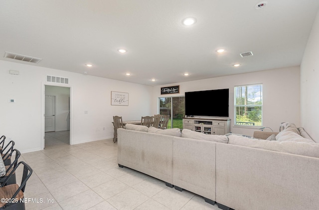 living area with light tile patterned floors, visible vents, and recessed lighting