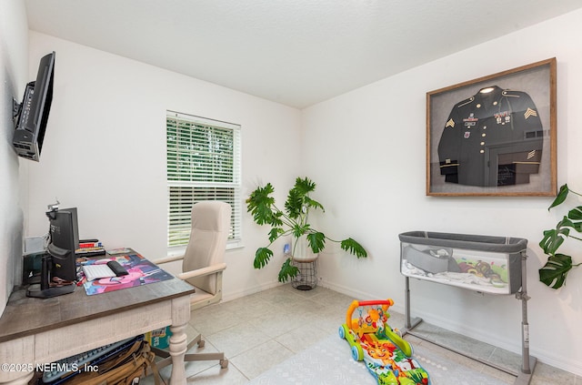 tiled office space featuring baseboards