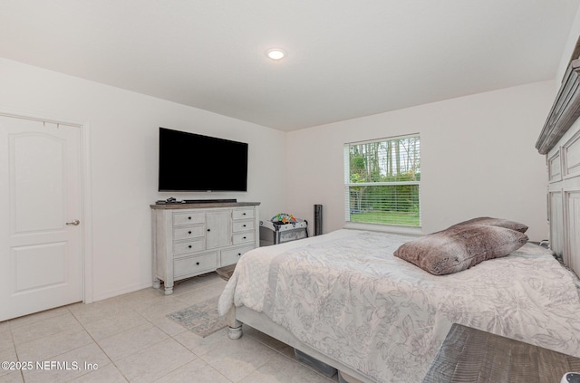 bedroom with light tile patterned floors and recessed lighting