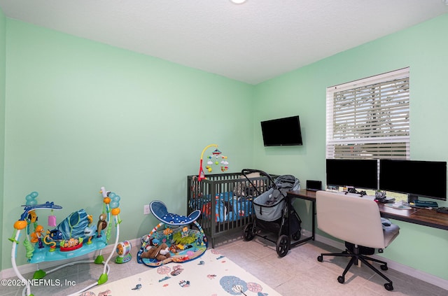 office area with tile patterned floors, a textured ceiling, and baseboards