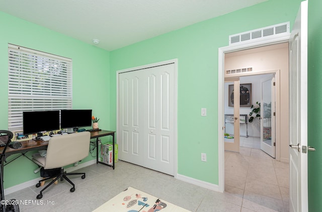 office with baseboards, french doors, visible vents, and tile patterned floors
