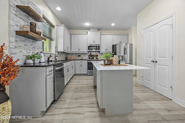 110 Arabian Ct, Saint Augustine, FL 32095 - kitchen featuring tasteful backsplash, light wood-style flooring, appliances with stainless steel finishes, and open shelves