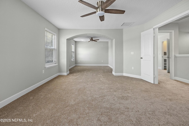 110 Arabian Ct, Saint Augustine, FL 32095 - carpeted empty room featuring a ceiling fan, a textured ceiling, baseboards, visible vents, and arched walkways