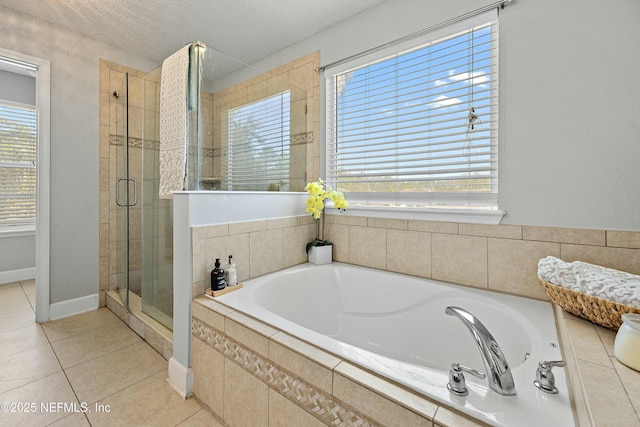 110 Arabian Ct, Saint Augustine, FL 32095 - bathroom featuring tile patterned floors, a bath, a textured ceiling, and a shower stall