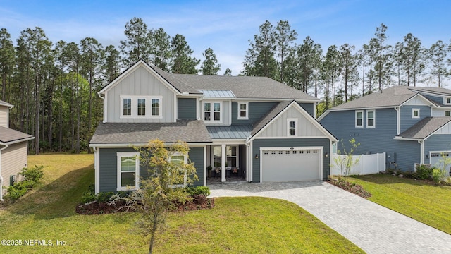 64 Whirlaway Ct, Saint Johns, FL 32259 - view of front facade with board and batten siding, decorative driveway, and a garage