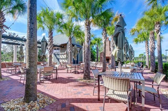 64 Whirlaway Ct, Saint Johns, FL 32259 - view of patio / terrace with an outdoor stone fireplace, a pergola, and outdoor dining space