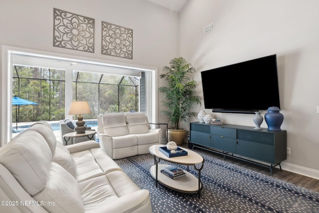 64 Whirlaway Ct, Saint Johns, FL 32259 - living area featuring wood finished floors, a towering ceiling, and baseboards