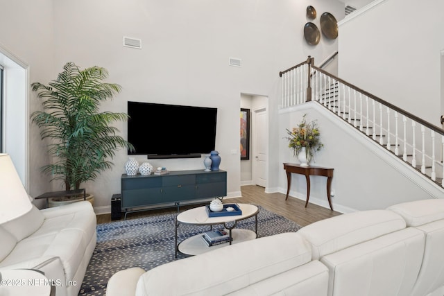 64 Whirlaway Ct, Saint Johns, FL 32259 - living room featuring wood finished floors, a high ceiling, stairway, and baseboards