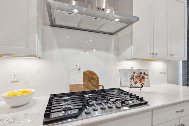 64 Whirlaway Ct, Saint Johns, FL 32259 - kitchen with ventilation hood, stainless steel gas cooktop, tasteful backsplash, and white cabinetry