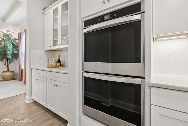 64 Whirlaway Ct, Saint Johns, FL 32259 - kitchen with double oven, white cabinets, glass insert cabinets, and crown molding