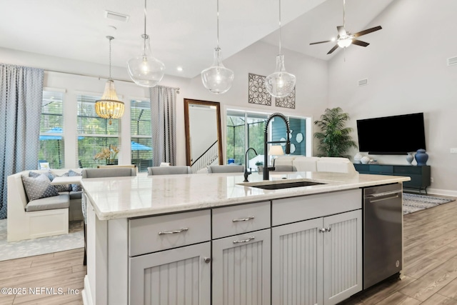 64 Whirlaway Ct, Saint Johns, FL 32259 - kitchen with open floor plan, a sink, light wood finished floors, stainless steel dishwasher, and high vaulted ceiling