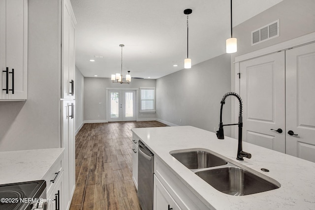 335 5th Ave S, Jacksonville Beach, FL 32250 - kitchen featuring white cabinets, visible vents, wood finished floors, stainless steel appliances, and a sink