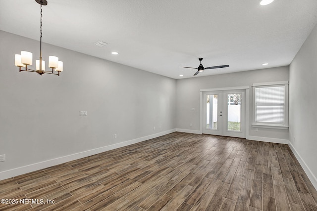 335 5th Ave S, Jacksonville Beach, FL 32250 - unfurnished living room with ceiling fan with notable chandelier, baseboards, and dark wood finished floors