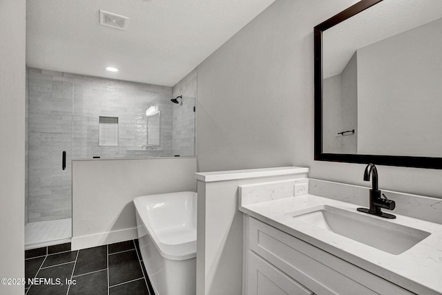 335 5th Ave S, Jacksonville Beach, FL 32250 - bathroom with visible vents, tile patterned floors, vanity, a stall shower, and a freestanding bath