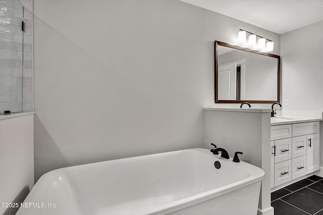 335 5th Ave S, Jacksonville Beach, FL 32250 - full bathroom with a textured ceiling, tile patterned floors, a soaking tub, and vanity
