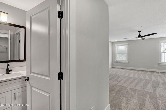 335 5th Ave S, Jacksonville Beach, FL 32250 - bathroom featuring baseboards, ceiling fan, vanity, and a textured ceiling
