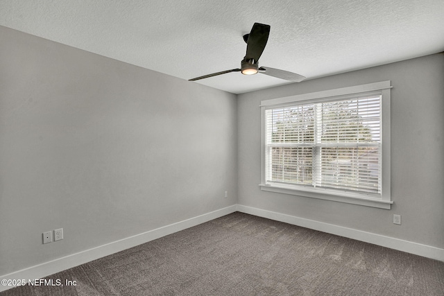 335 5th Ave S, Jacksonville Beach, FL 32250 - empty room with baseboards, a textured ceiling, dark carpet, and a ceiling fan