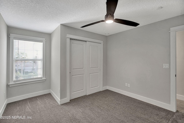 335 5th Ave S, Jacksonville Beach, FL 32250 - unfurnished bedroom with a closet, carpet flooring, a textured ceiling, baseboards, and ceiling fan