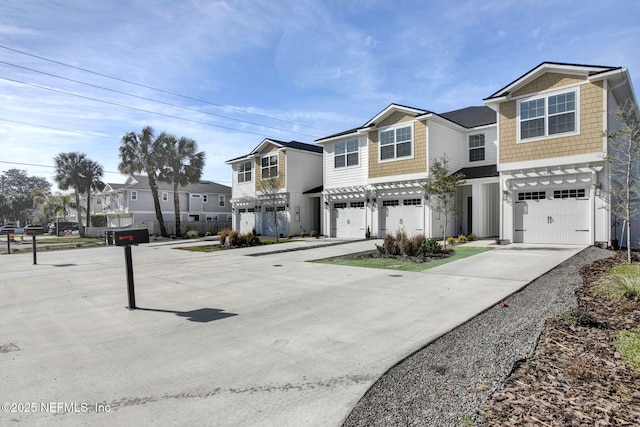 335 5th Ave S, Jacksonville Beach, FL 32250 - view of front of house featuring a residential view, an attached garage, and concrete driveway