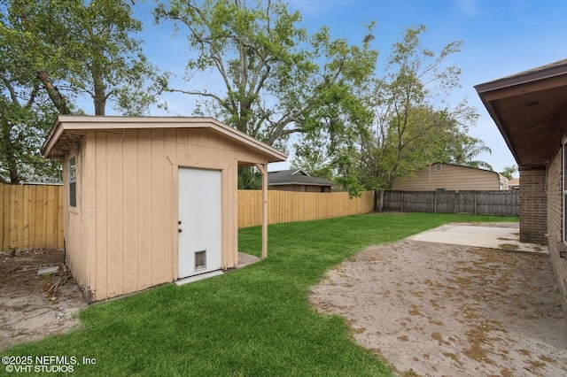 7927 Dwyer Dr, Jacksonville, FL 32244 - view of yard featuring a fenced backyard, a shed, an outbuilding, and a patio